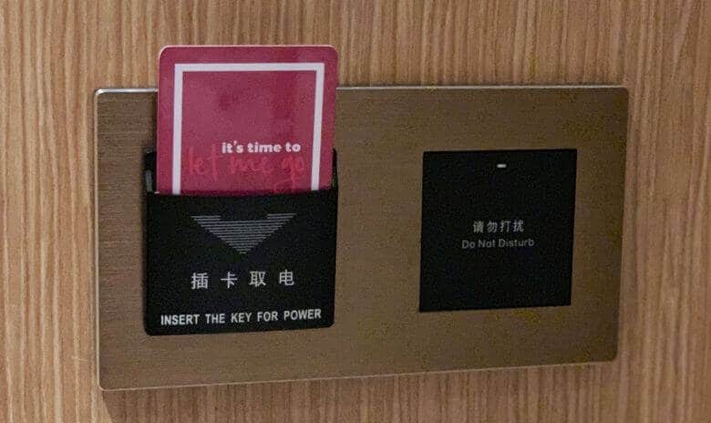 Insert key card to hotel energy-saving switch to the power room